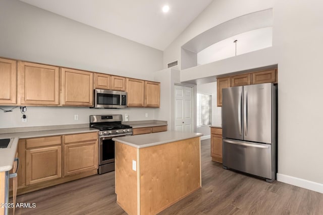 kitchen featuring wood finished floors, visible vents, baseboards, light countertops, and appliances with stainless steel finishes