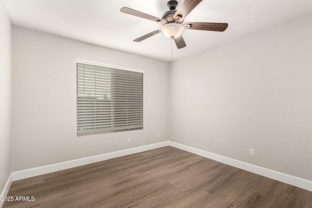 spare room featuring ceiling fan, wood finished floors, and baseboards