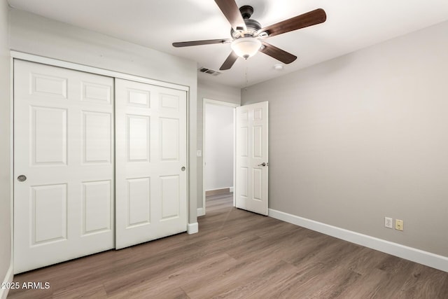 unfurnished bedroom featuring a closet, light wood-type flooring, visible vents, and baseboards