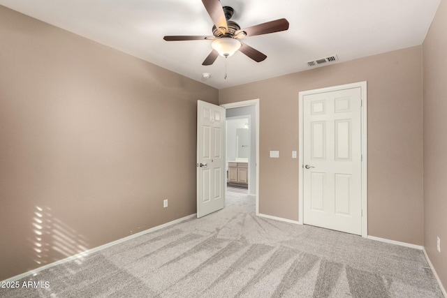 unfurnished bedroom featuring light colored carpet, visible vents, and baseboards