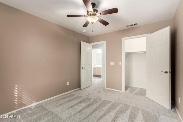 unfurnished bedroom with light carpet, a closet, visible vents, and baseboards