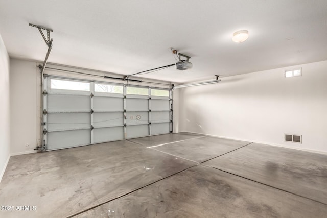 garage with visible vents and a garage door opener