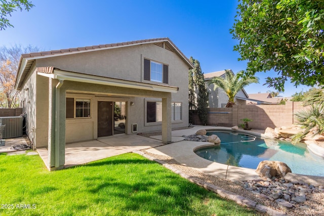 rear view of property with a fenced in pool, a patio, stucco siding, a lawn, and a fenced backyard