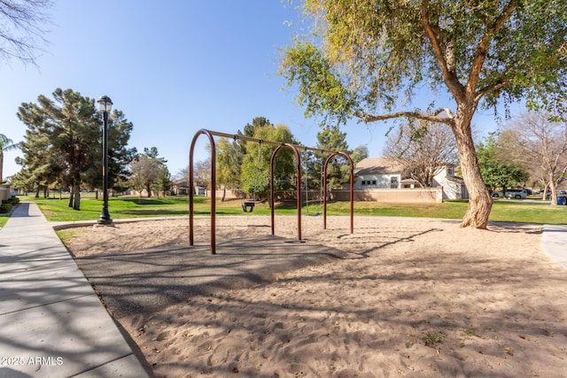 view of community with playground community and a lawn