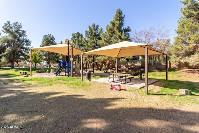 community play area featuring a gazebo and fence