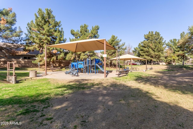 community play area with a yard and fence