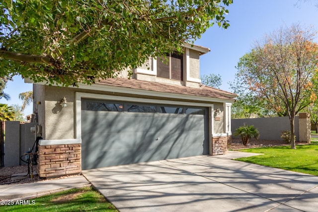 garage with concrete driveway and fence