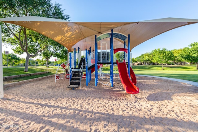 community jungle gym featuring a lawn