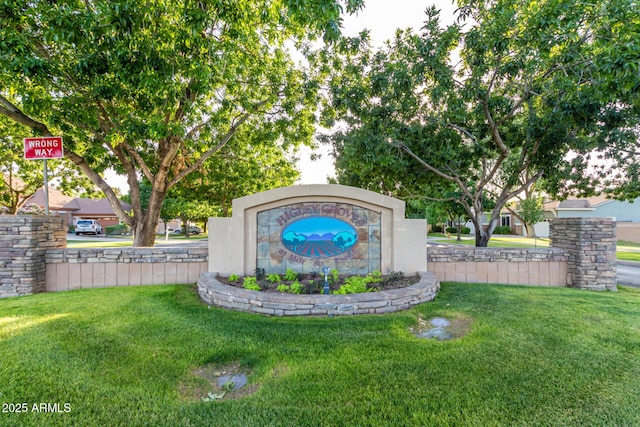 community sign featuring a lawn