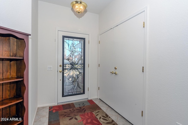 foyer entrance featuring light tile patterned flooring