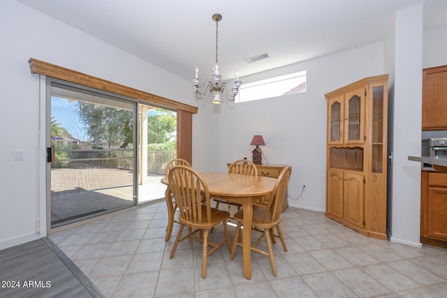 tiled dining space featuring a chandelier