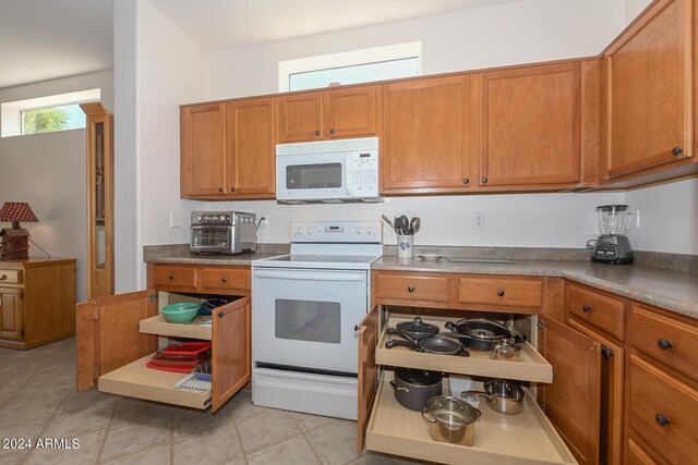 kitchen with white appliances and light tile patterned floors