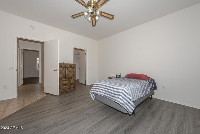 bedroom with wood-type flooring and ceiling fan