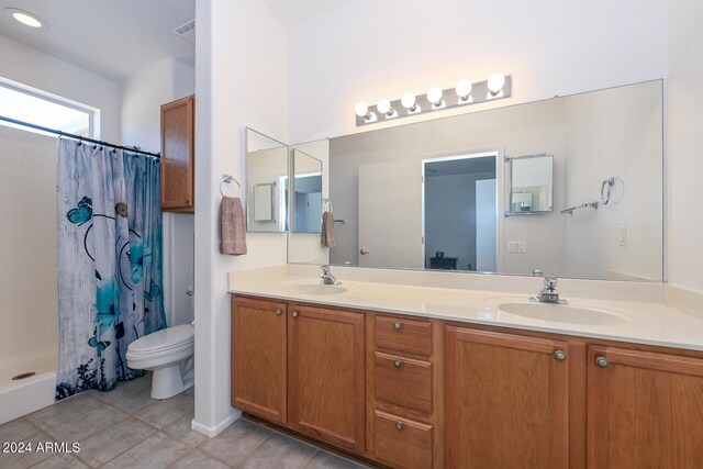 bathroom with vanity, toilet, a shower with curtain, and tile patterned floors