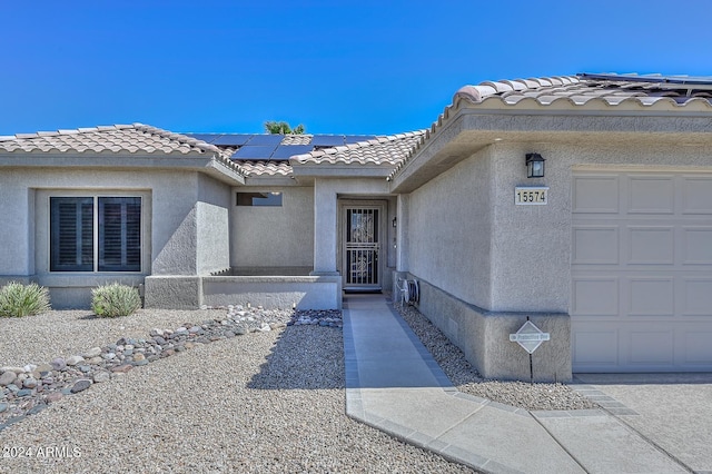 doorway to property with a garage