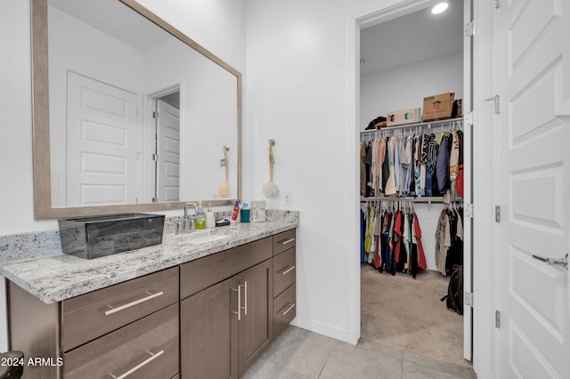 bathroom featuring tile patterned flooring and vanity