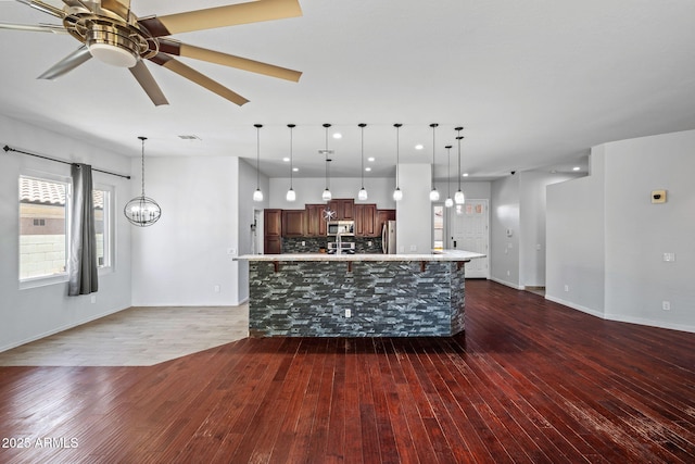 7911 E Posada Ave, Mesa, AZ 85212 - kitchen featuring stainless steel appliances, dark wood finished floors, a ceiling fan, light countertops, and recessed lighting