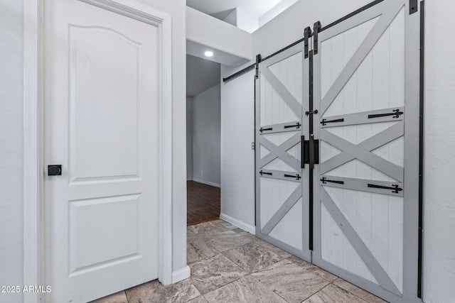 7911 E Posada Ave, Mesa, AZ 85212 - hall featuring a barn door and baseboards