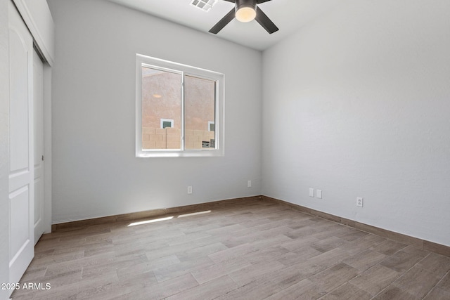 7911 E Posada Ave, Mesa, AZ 85212 - unfurnished bedroom featuring wood finished floors, a closet, and a ceiling fan