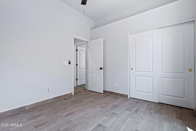 7911 E Posada Ave, Mesa, AZ 85212 - unfurnished bedroom with light wood-type flooring, a closet, and a ceiling fan