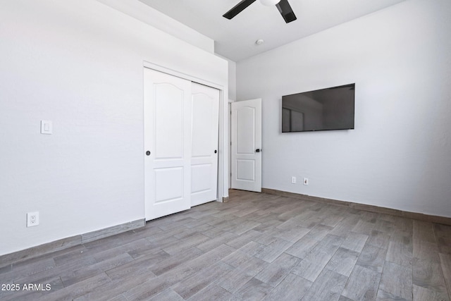 7911 E Posada Ave, Mesa, AZ 85212 - unfurnished bedroom featuring wood finished floors, a closet, and ceiling fan
