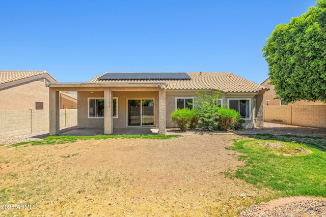 7911 E Posada Ave, Mesa, AZ 85212 - rear view of property with solar panels, a fenced backyard, and stucco siding