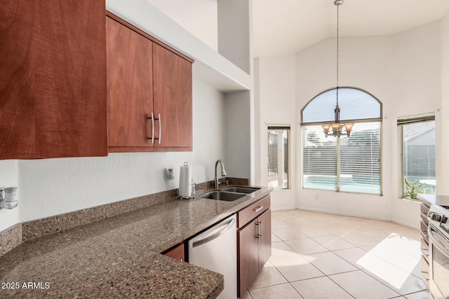 kitchen featuring pendant lighting, sink, dark stone counters, stainless steel dishwasher, and a notable chandelier