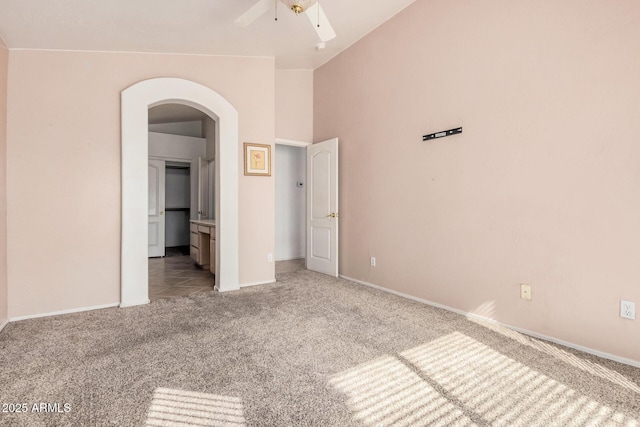 unfurnished bedroom with lofted ceiling, light colored carpet, and ceiling fan