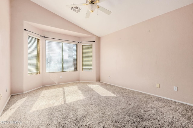 carpeted spare room with ceiling fan and lofted ceiling