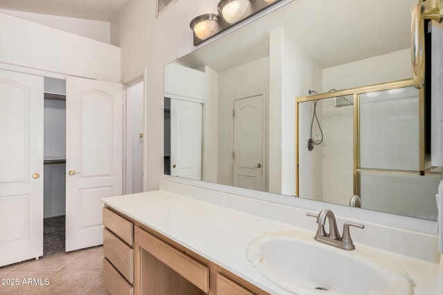 bathroom with walk in shower, tile patterned floors, and vanity