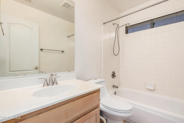 full bathroom featuring vanity, toilet, and tiled shower / bath combo