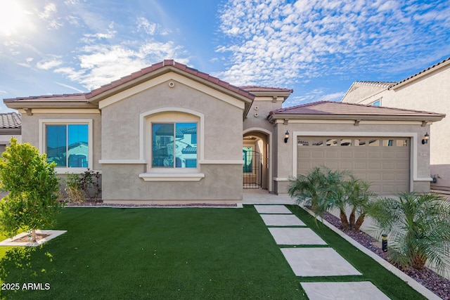 mediterranean / spanish-style house with a garage, a front lawn, a tile roof, and stucco siding