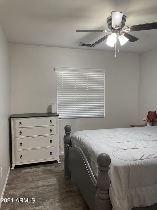 bedroom with ceiling fan and dark hardwood / wood-style floors