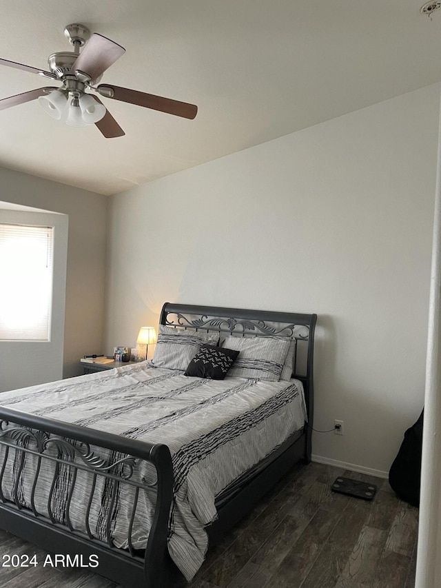 bedroom with ceiling fan and dark hardwood / wood-style flooring