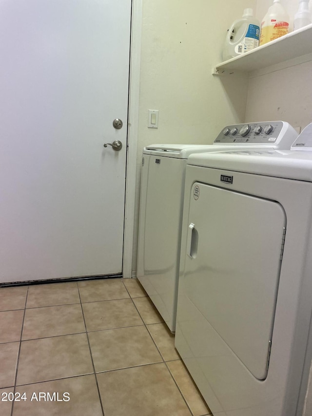 clothes washing area featuring light tile patterned floors and independent washer and dryer