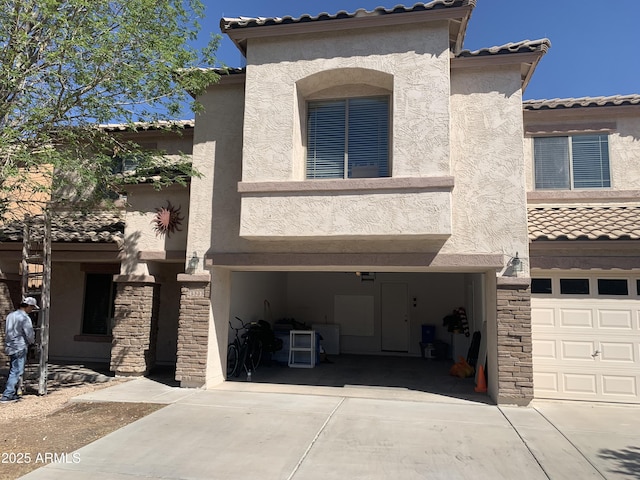 43232 W Magnolia Rd, Maricopa, AZ 85138 - mediterranean / spanish-style home featuring a tiled roof, a garage, stucco siding, and concrete driveway