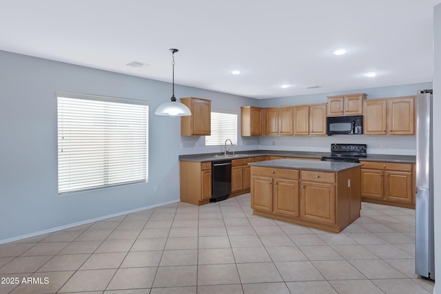 43232 W Magnolia Rd, Maricopa, AZ 85138 - kitchen with black appliances, a center island, a sink, decorative light fixtures, and baseboards