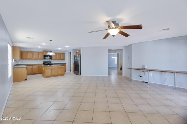 43232 W Magnolia Rd, Maricopa, AZ 85138 - kitchen with stainless steel fridge with ice dispenser, black microwave, stove, light countertops, and ceiling fan