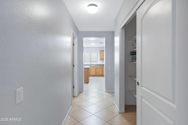 43232 W Magnolia Rd, Maricopa, AZ 85138 - hall with light tile patterned flooring, a sink, and baseboards