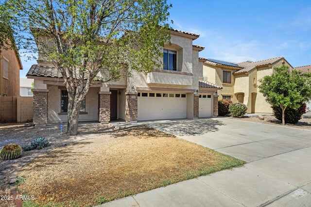 43232 W Magnolia Rd, Maricopa, AZ 85138 - view of front facade with stucco siding, a garage, a tiled roof, and concrete driveway