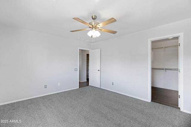 43232 W Magnolia Rd, Maricopa, AZ 85138 - unfurnished bedroom featuring carpet floors, baseboards, a spacious closet, and a ceiling fan