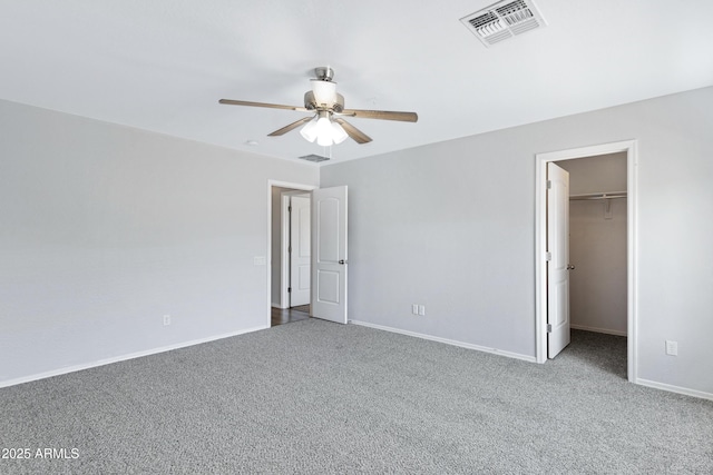 43232 W Magnolia Rd, Maricopa, AZ 85138 - unfurnished bedroom featuring carpet, a spacious closet, baseboards, and ceiling fan