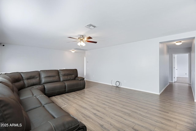 43232 W Magnolia Rd, Maricopa, AZ 85138 - living area featuring ceiling fan, baseboards, and light wood finished floors