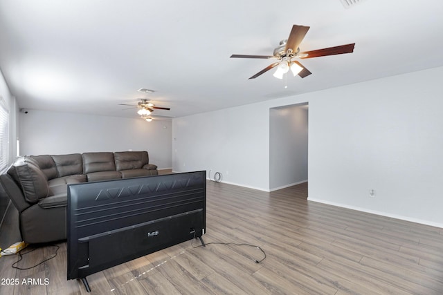 43232 W Magnolia Rd, Maricopa, AZ 85138 - living room featuring ceiling fan, wood finished floors, and baseboards