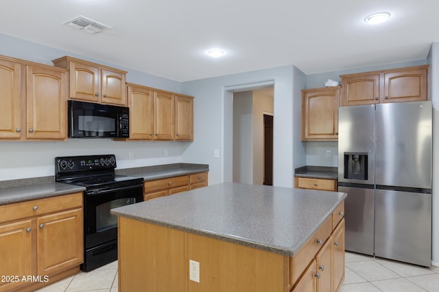43232 W Magnolia Rd, Maricopa, AZ 85138 - kitchen with black appliances, dark countertops, light tile patterned floors, and a kitchen island