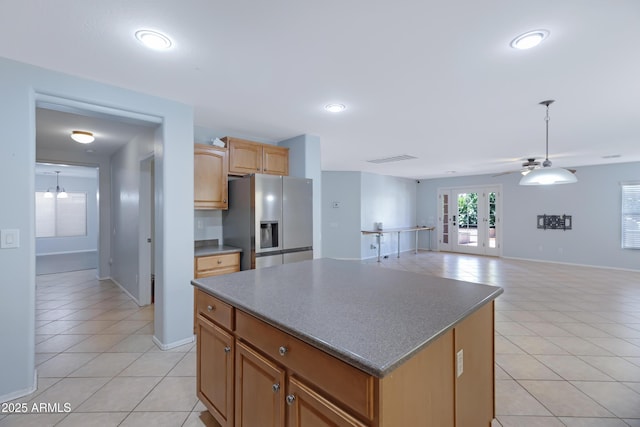 43232 W Magnolia Rd, Maricopa, AZ 85138 - kitchen featuring stainless steel fridge with ice dispenser, light tile patterned floors, french doors, a kitchen island, and recessed lighting