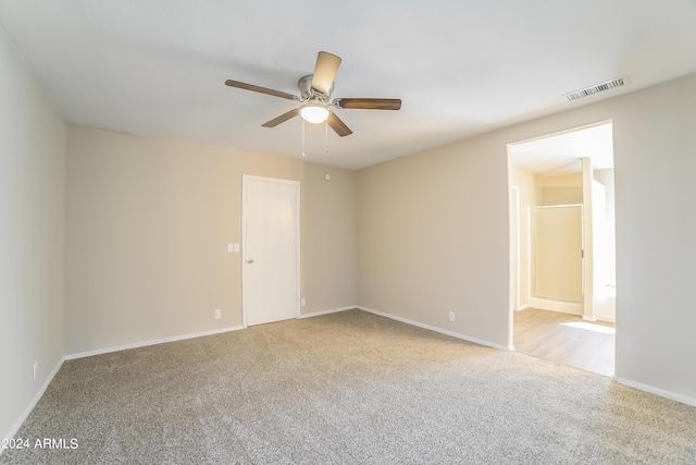 spare room featuring ceiling fan and light carpet