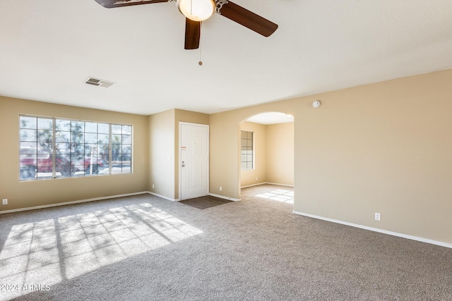 spare room with ceiling fan and light colored carpet