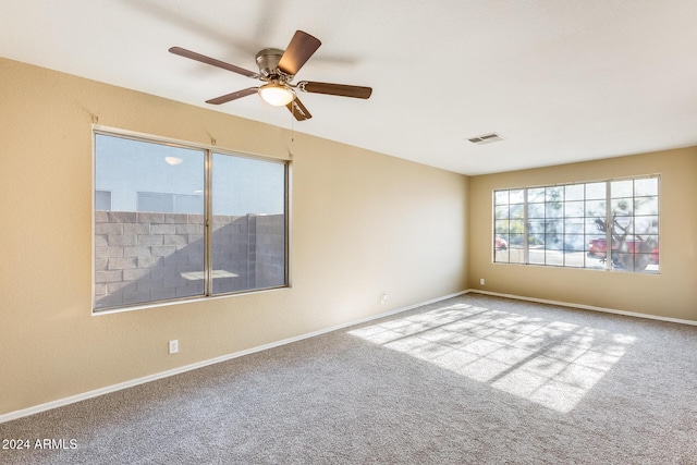 spare room with light colored carpet and ceiling fan