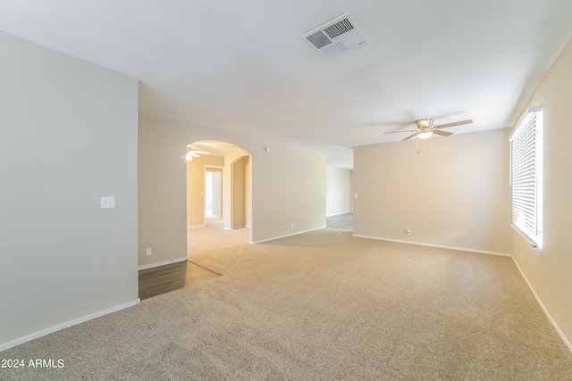 spare room with light carpet and ceiling fan